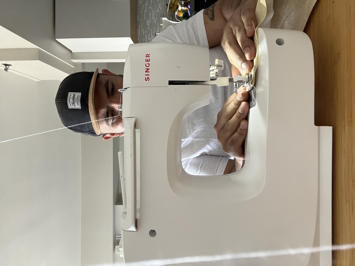 Julian Catzim working at the sewing machine